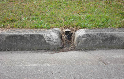 Ineffective stormwater control - old and weathered kerb adaptors